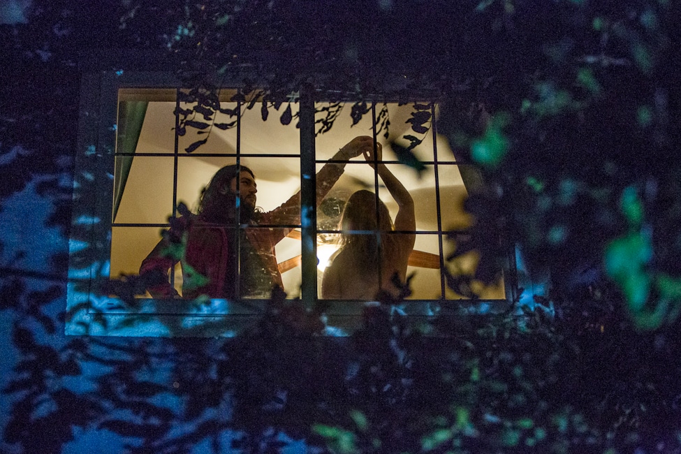 Caroline White's Looking Thru Glass Man and Woman dancing behind the window