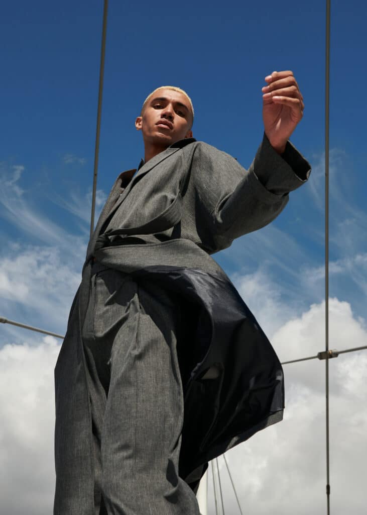 low angle view of male fashion model posing in city