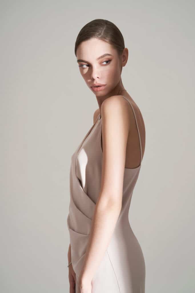 Beautiful woman pose in studio in classic dress