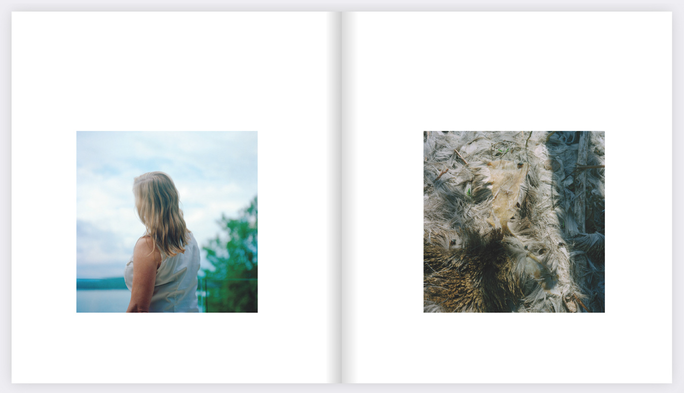The image is a two-page spread from a book, with a square photo on each page; the left photo shows a woman with blonde hair looking out over a lake, and the right photo shows a close-up of matted, dirty feathers. The photos are presented in a soft, slightly faded style.