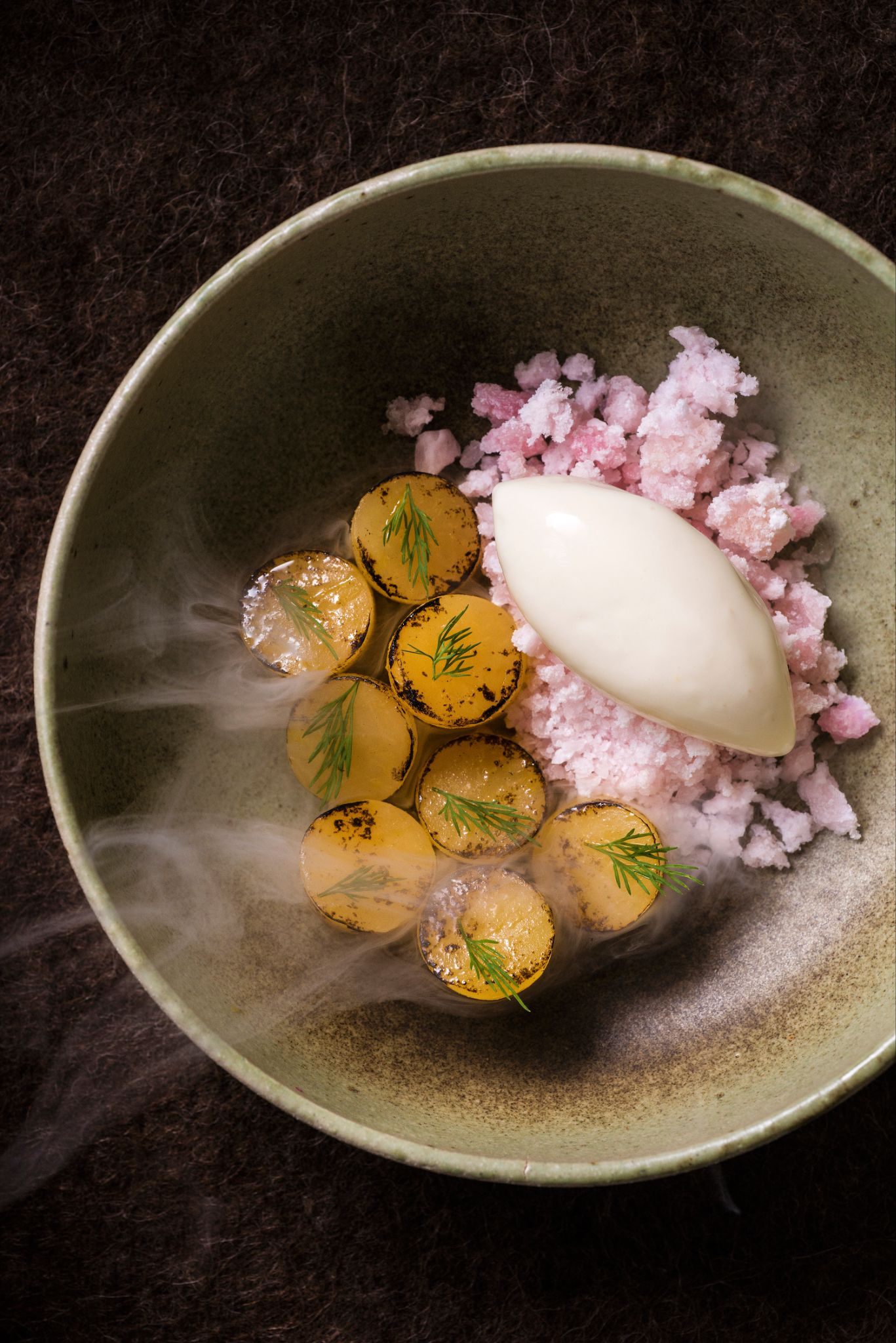Gourmet burned rutabaga dish with apple cider spheres, dill, and pink granita