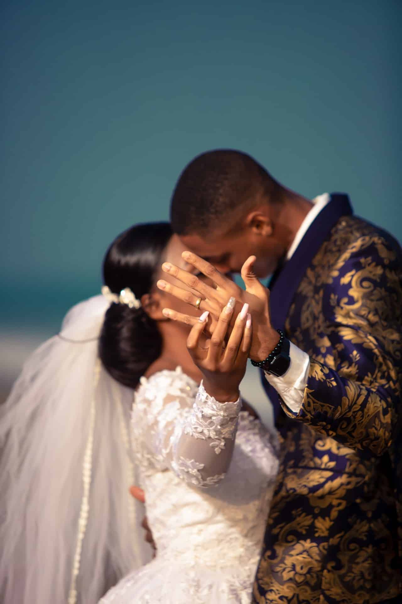 Couple kissing showing wedding ring