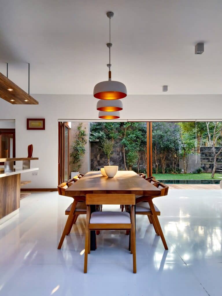 Interior dining room space with modern furniture and warm pendant lights