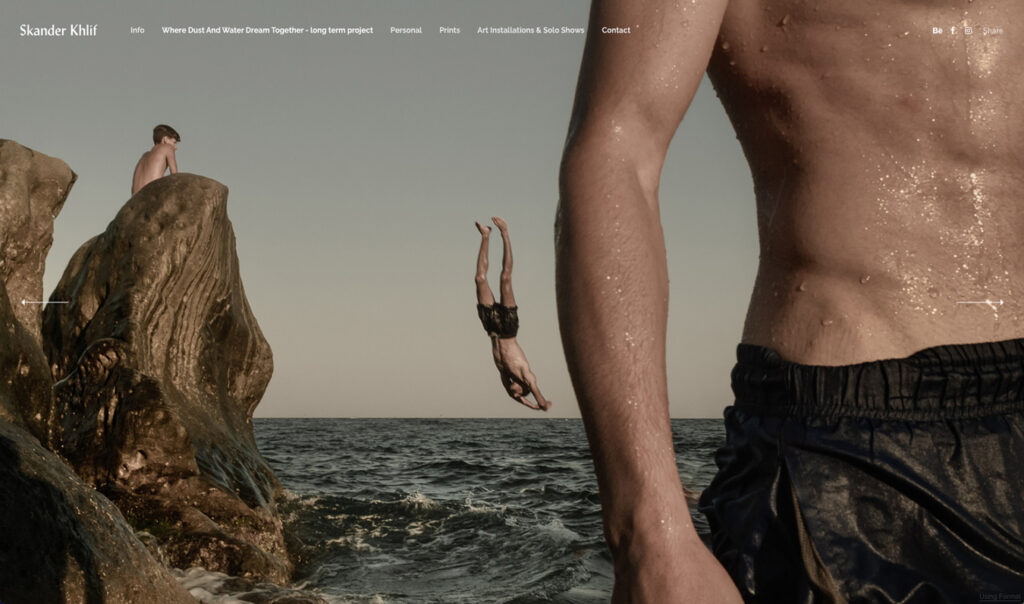 On the homepage of Skander Khlif's portfolio website, the feature image shows a young man dives headfirst into the ocean, framed by a large rock formation on the left and the torso of another person on the right, with water droplets glistening on their skin. Another figure sits atop the rocks in the background.