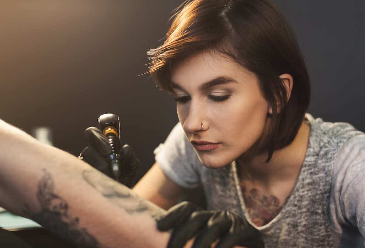 a-professional-tattooer-artist-doing-picture-on-ASFGTCU