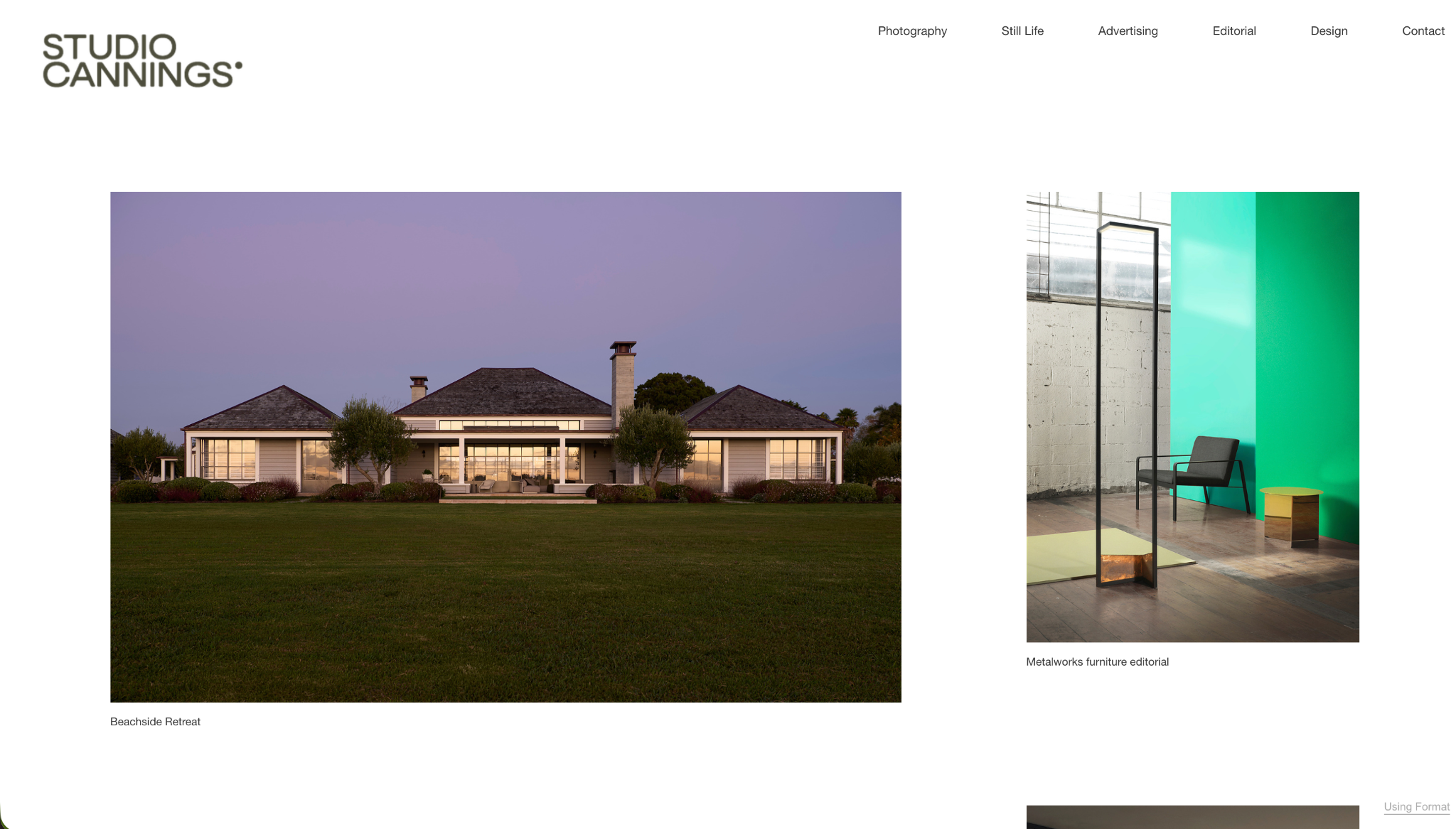 Contemporary beachside home photographed at dusk with a wide green lawn