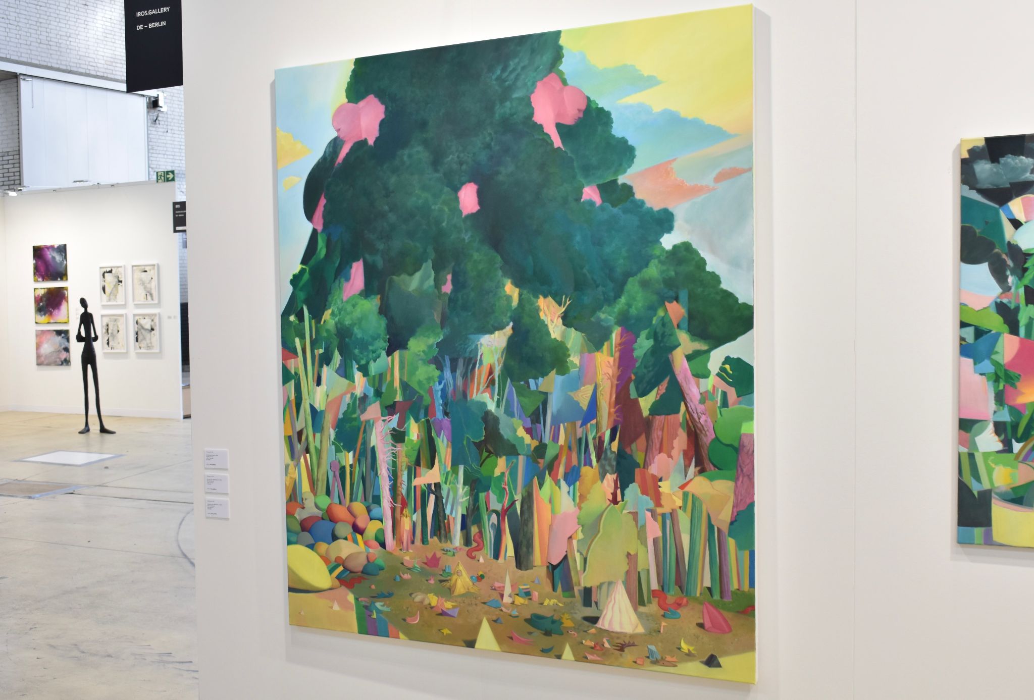 Large colorful forest painting displayed in a contemporary Berlin art gallery