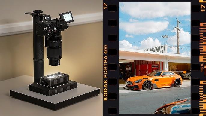 Film scanner digitizing a photo of an orange sports car