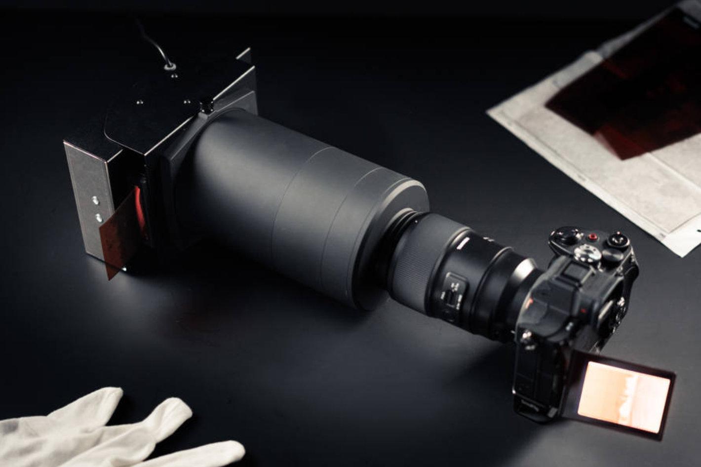 Camera lens mounted for film scanning with light source and negative holder