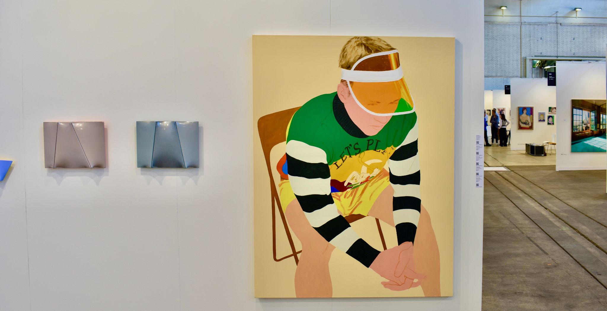 Large gallery painting depicts a seated person in an orange visor and green striped shirt.