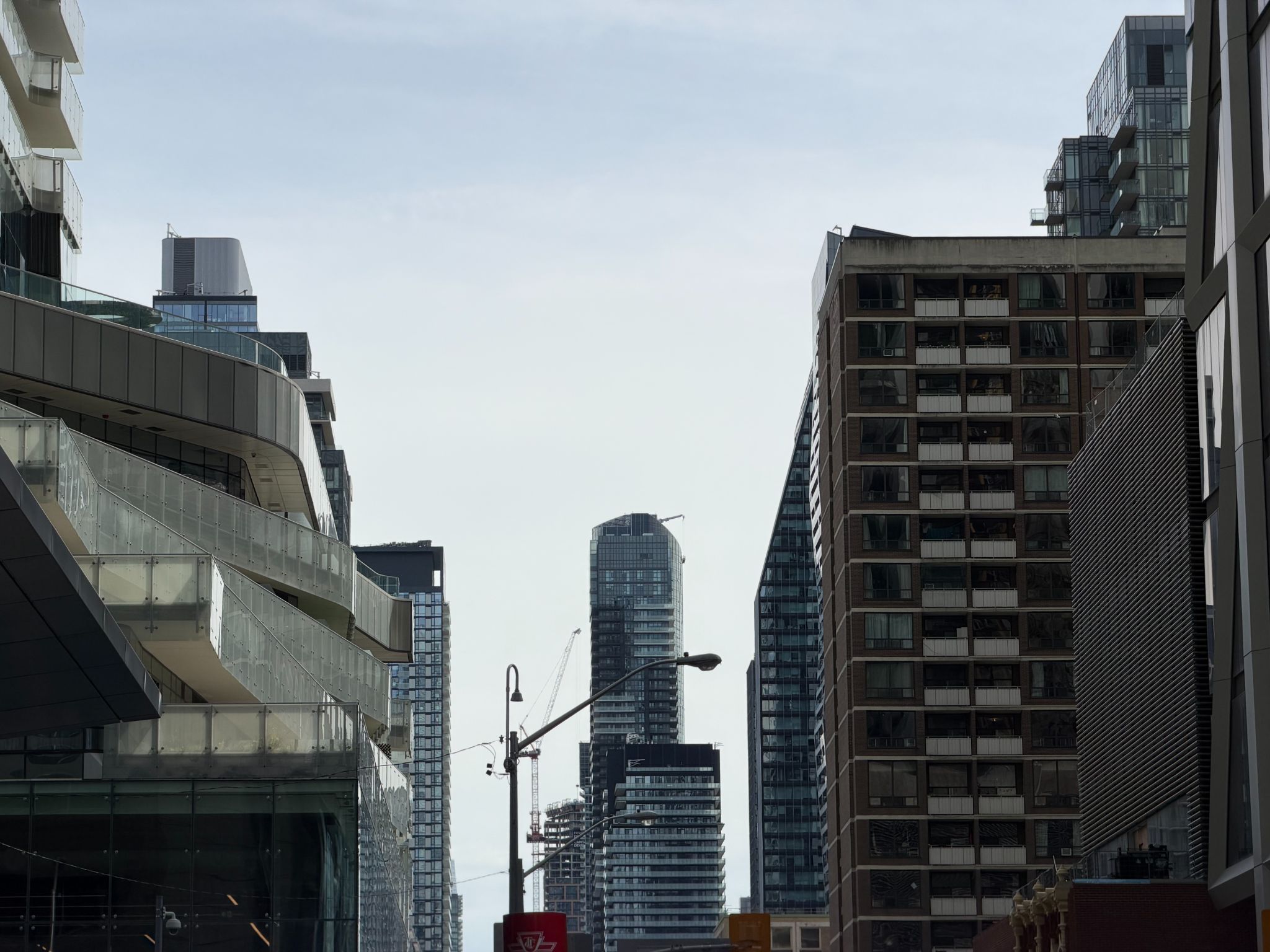 Modern city skyscrapers and construction cranes framed by downtown buildings