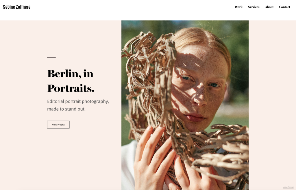 A website homepage for Sabine Zoltner features a close-up portrait of a freckled, red-haired woman holding a textured, shredded cardboard sculpture that casts intricate shadows across her face.
