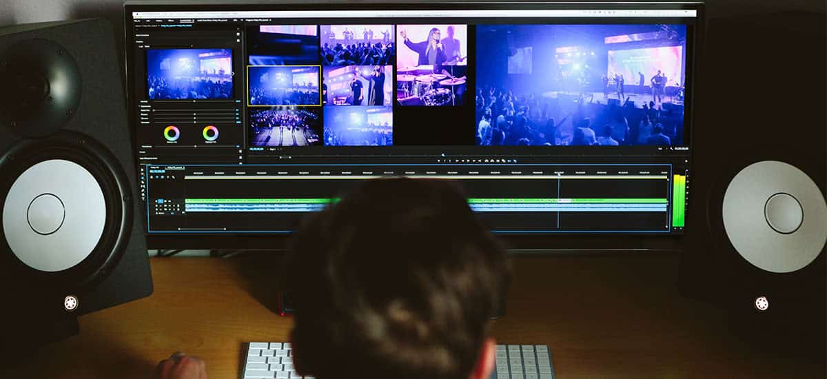 chico-editando-en-un-monitor-de-pantalla-ancha