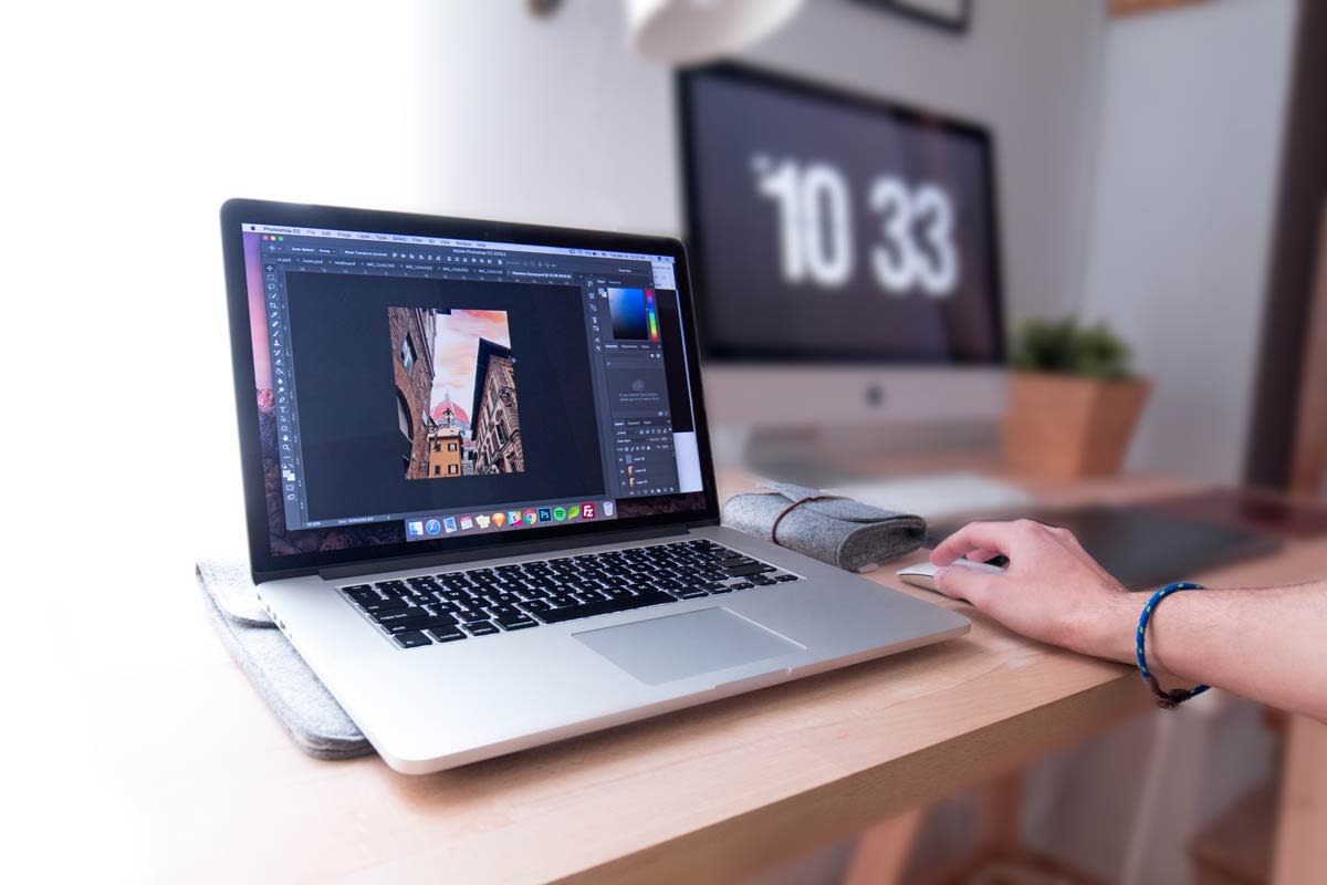 macbook on a desk with photoshop