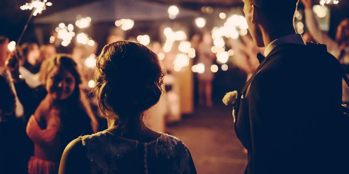 man-and-woman-walking-with-sparkler-bokeh-in-the-backgroud