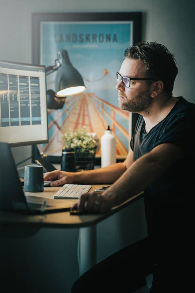 man working on web design mockups in a home office