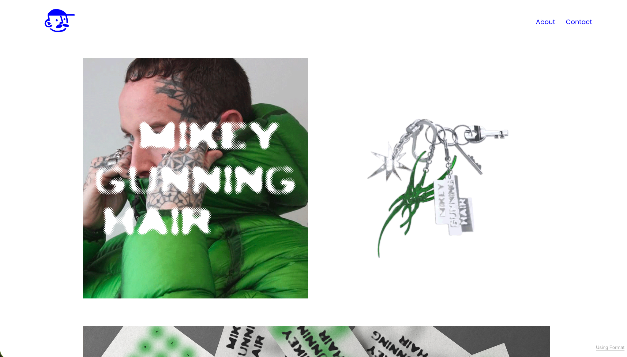Tattooed model in green fashion beside silver keys and green accessories
