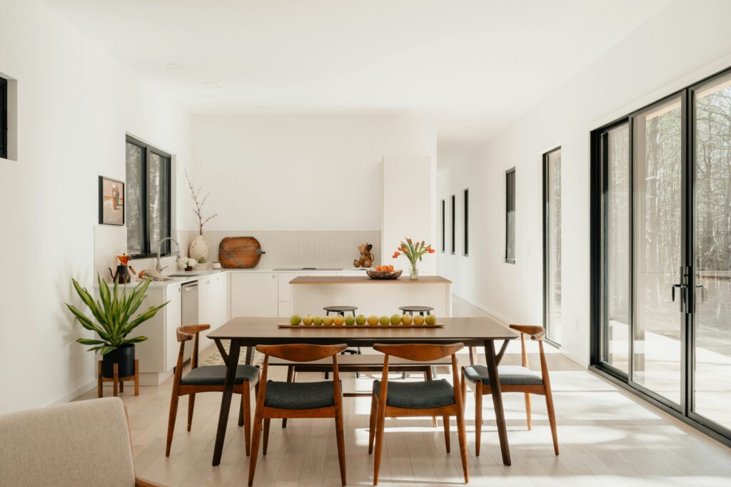 modern dining table in open plan kitchen with white walls