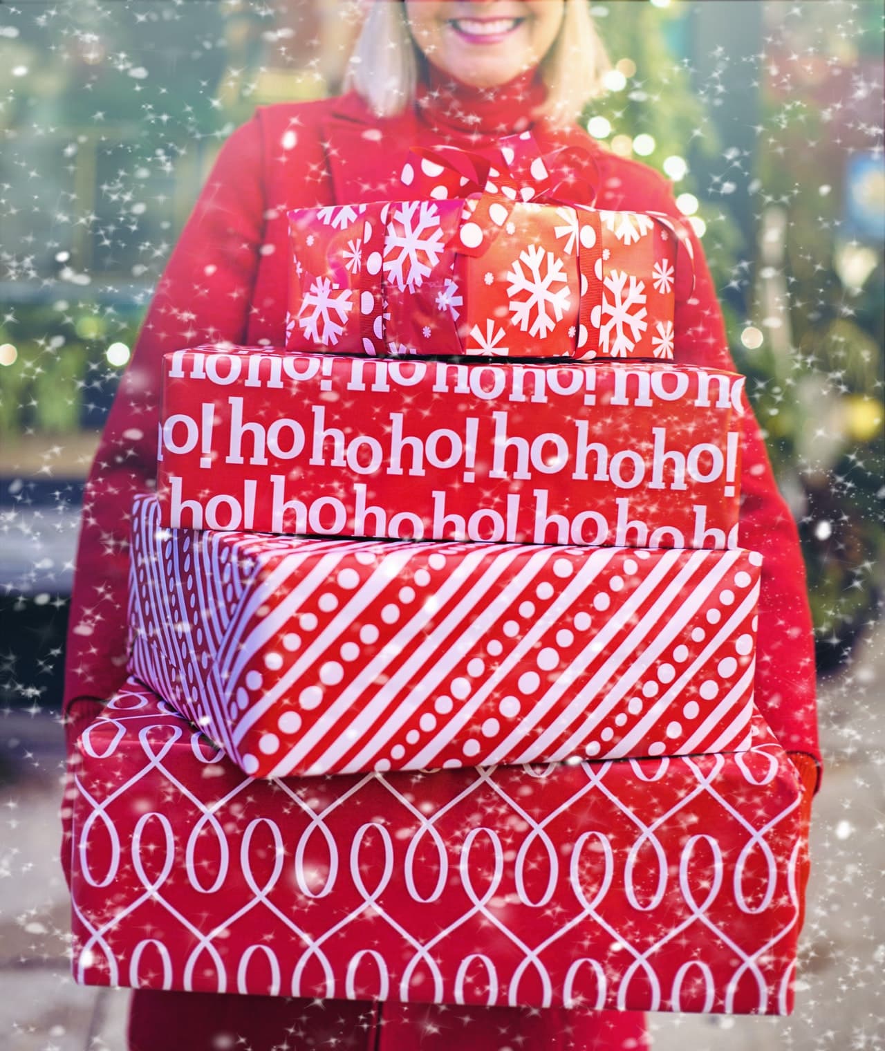 Holding christmas presents in the snow