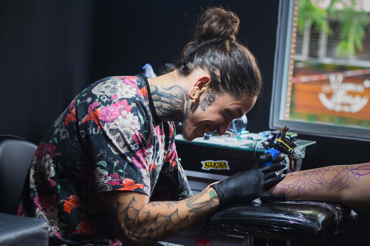 tatuador tatuando un brazo
