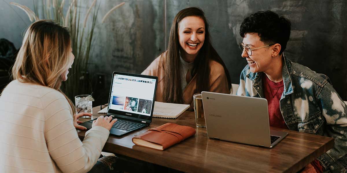 three-college-students-putting-their-online-photography-portfolios-together