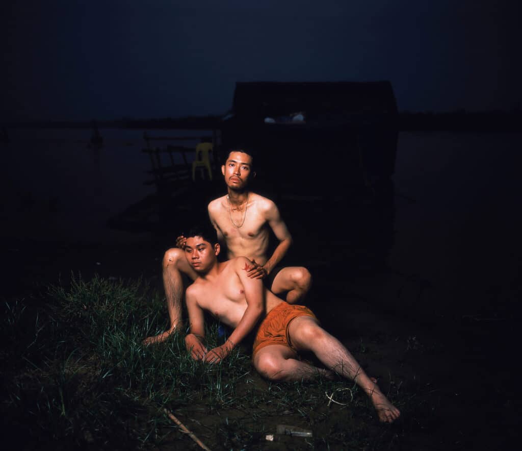 Photo by Van Nhi Nguyen showing two male figures resting on one another wearing their undershorts