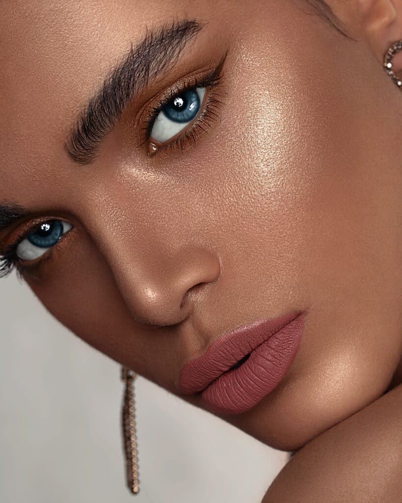woman with shimmery bronze makeup and bold eyebrows