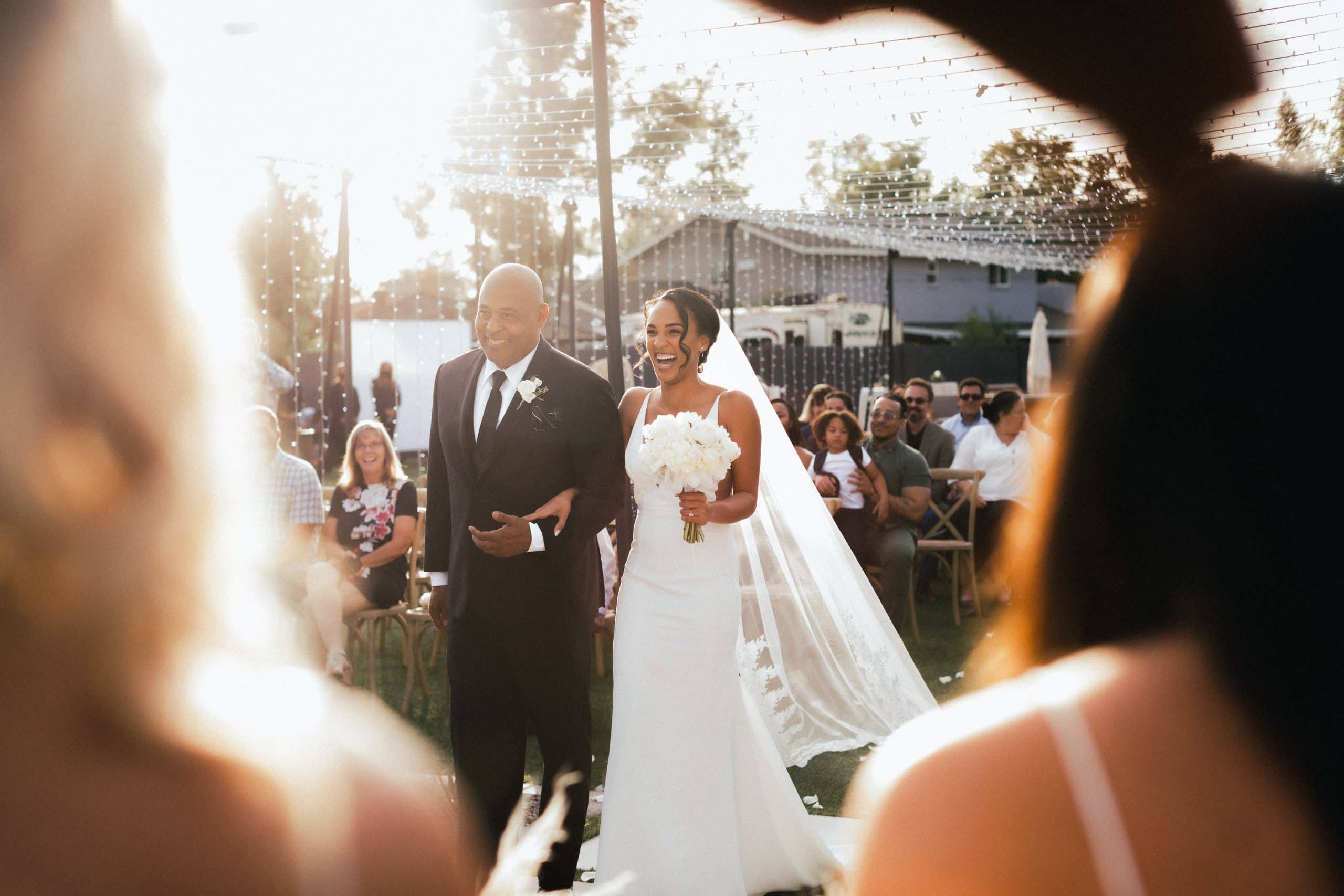 woman_smiling_with_man_down_the_aisle scaled